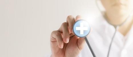 doctor holding a stethoscope in his hand Plus icon, detailed physical examination and patient analysis. photo