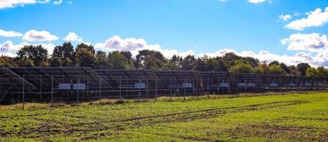 Generating clean energy with solar modules in a big park in northern Europe photo