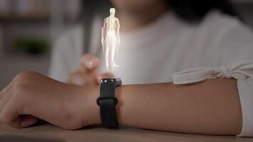 el primer plano de la mano femenina con un reloj inteligente futurista interactúa con un holograma hud. mujer usa tecnología holográfica del futuro en un reloj de pulsera. concepto médico y de estilo de vida. video