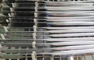 Selective focus of shiny cutlery in a dishwasher after cleaning. Forks, Knifes and Spoons photo