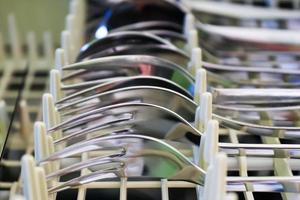 Selective focus of shiny cutlery in a dishwasher after cleaning. Forks, Knifes and Spoons photo