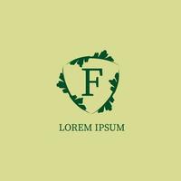 Letter F alphabetic logo design template isolated on green beige color. Nature Guard, Security logo concept. Decorative floral shield sign illustration. vector