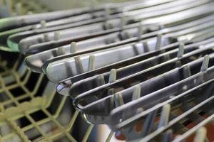 Selective focus of shiny cutlery in a dishwasher after cleaning. Forks, Knifes and Spoons photo