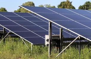 Generating clean energy with solar modules in a big park in northern Europe photo