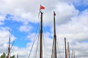 Sailing ship mast against the blue sky on some sailing boats with rigging details. photo