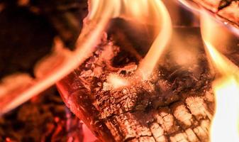 Beautiful red and orange hot burning fire in a fireplace photo