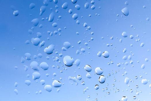 Rain drops running down a window in a close up view. photo