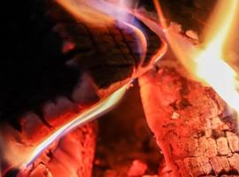 Beautiful red and orange hot burning fire in a fireplace photo