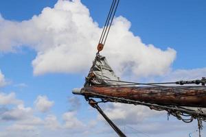 Sailing ship mast against the blue sky on some sailing boats with rigging details. photo
