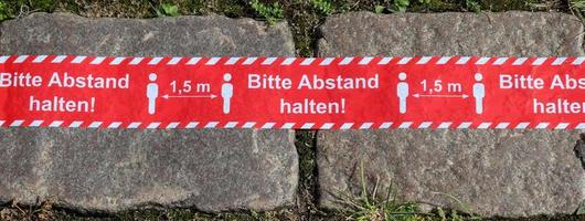 Keep distance symbol in german language 2 meter social distancing sign for COVID 19. photo