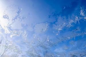 Beautiful ice flowers at a window on a very cold winter day. photo