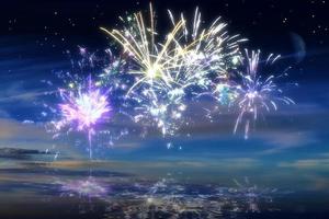 Beautiful happy new year fireworks in the sky with reflections on water photo