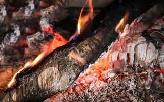 Beautiful red and orange hot burning fire in a fireplace photo