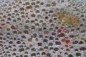 Hot water drops condensating at a glass pot cover during cooking. photo