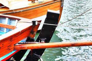 Sailing ship mast against the blue sky on some sailing boats with rigging details. photo