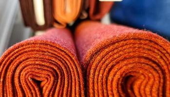 Detailed close up view on samples of cloth and fabrics in different colors found at a fabrics market photo