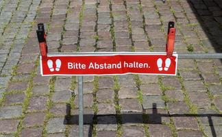 Keep distance symbol in german language 2 meter social distancing sign for COVID 19. photo