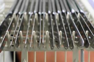 Selective focus of shiny cutlery in a dishwasher after cleaning. Forks, Knifes and Spoons photo