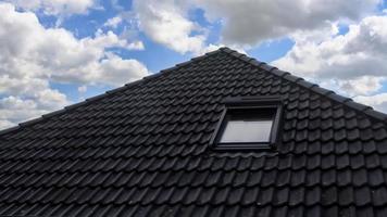 Open roof window in velux style with black roof tiles. photo