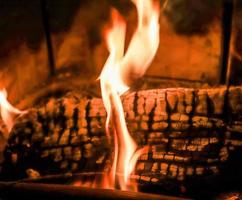 Beautiful red and orange hot burning fire in a fireplace photo