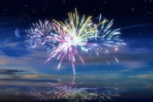 Beautiful happy new year fireworks in the sky with reflections on water photo