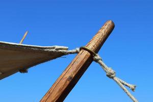 Old vikings tent made of wood and cloth in front of a blue sky photo