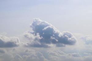 Beautiful fluffy white cloud formations in a deep blue summer sky photo