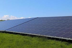 Generating clean energy with solar modules in a big park in northern Europe photo