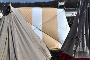 Old vikings tent made of wood and cloth in front of a blue sky photo