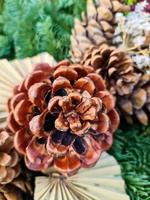 Selective focus of a beautiful arrangement of fir branches and cones at Christmas time. photo