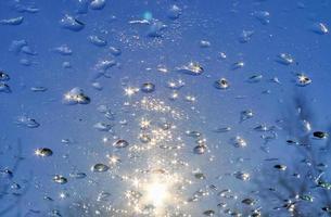 Sunlight reflections in frozen ice drops on a window. photo