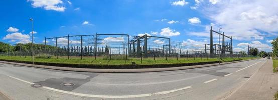 Electrical Transformer. Distribution of electric energy at a big substation with lots power lines on a sunny day photo