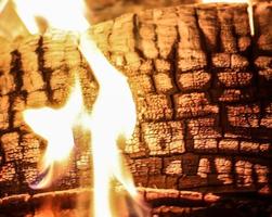 Beautiful red and orange hot burning fire in a fireplace photo