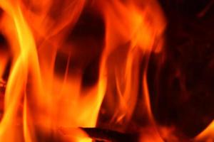 Beautiful red and orange hot burning fire in a fireplace photo