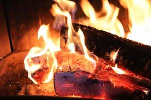 Beautiful red and orange hot burning fire in a fireplace photo