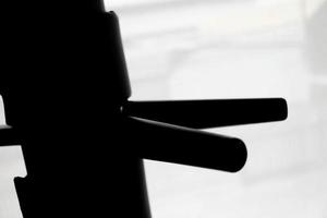 Silhouette of wooden dummy on a background. Wing Chun Kung Fu Self defense photo