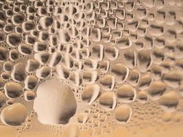 Water drops background texture. Backdrop glass covered with drops of water. bubbles in water photo