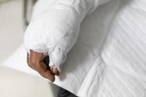 Patient with burns in the hospital. applying bandage onto patient's arm burn wound. photo