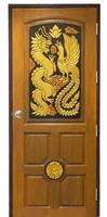 Carved wooden door decorated with dragons, swans and golden flowers photo