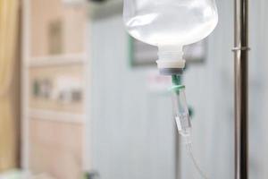 Saline bag intravenous drip hospital room,Medical Concept, treatment patient emergency and injection drug infusion care chemotherapy concept. selective focus photo