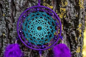 Handmade dream catcher with feathers threads and beads rope hanging photo