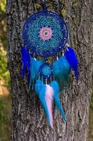 Handmade dream catcher with feathers threads and beads rope hanging photo