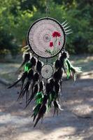 Handmade dream catcher with feathers threads and beads rope hanging photo