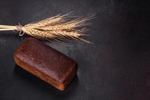 Sliced rye bread on cutting board. Whole grain rye bread with seeds photo