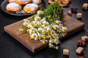 ramo de flores de manzanilla de jardín sobre una mesa de hormigón amarillo foto