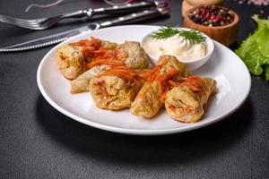 Cabbage rolls stuffed with ground beef and rice served on a white plate photo