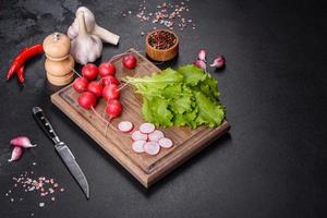 Fresh, delicious lettuce leaves on a brown wooden cutting board photo