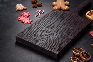 Christmas table setting with empty black ceramic plate, fir tree and black accessories photo