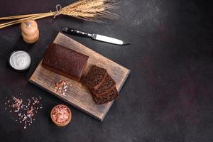 Sliced rye bread on cutting board. Whole grain rye bread with seeds photo