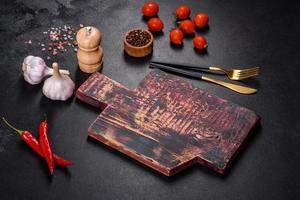 An empty plate with a knife, fork or spoon with a wooden cutting board photo